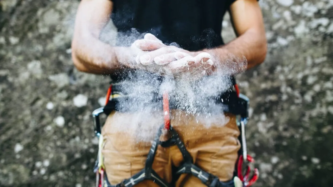 Close up on a plate of mashed potatoes, topped with baked pork chops with cream of mushroom soup, and a side of green beans.