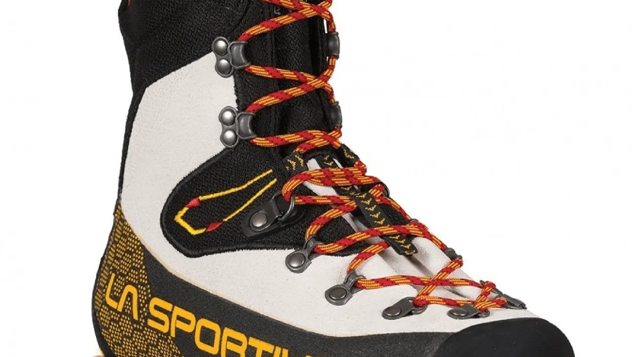 Close up on a plate of mashed potatoes, topped with baked pork chops with cream of mushroom soup, and a side of green beans.